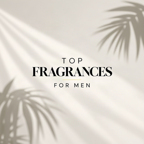 Promotional graphic with the text 'TOP FRAGRANCES FOR MEN' in black serif lettering on a warm off-white background with soft palm leaf shadows.